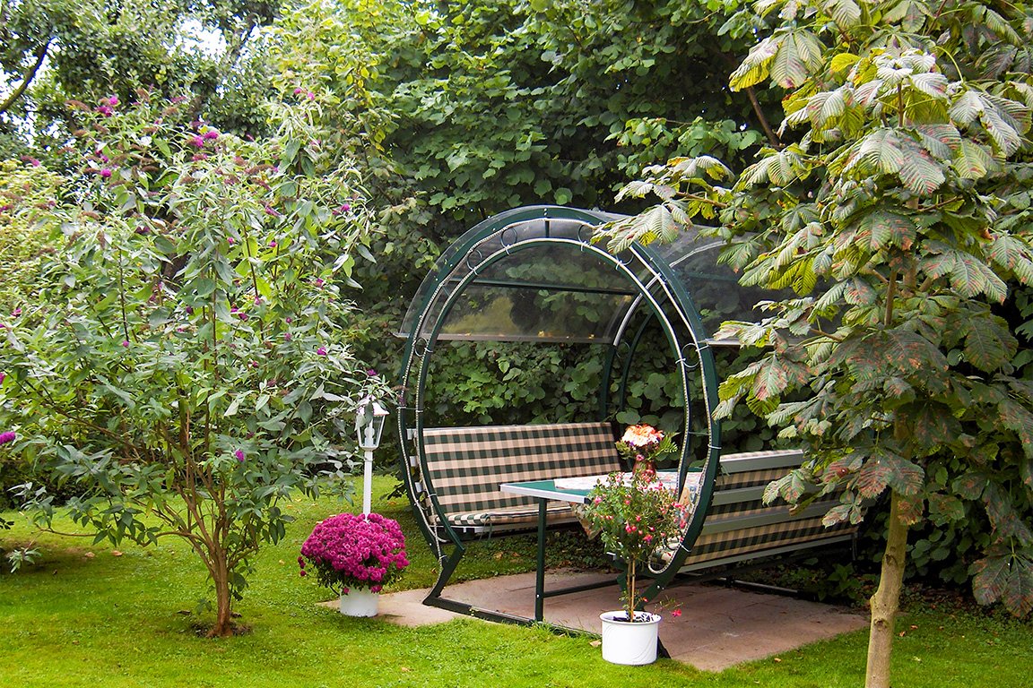 Rhönrad bench in the garden in fir green