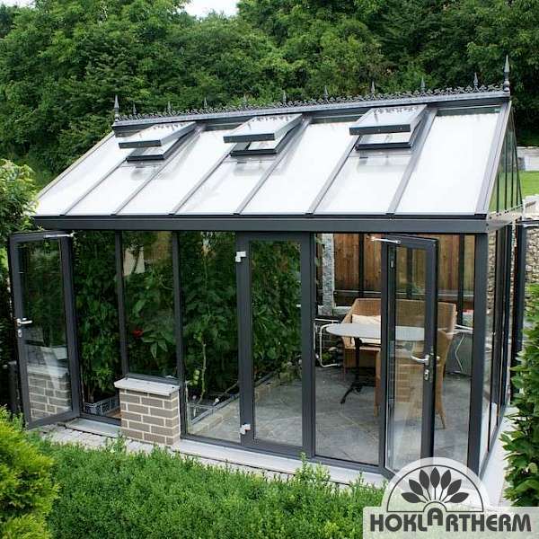 Vario TH greenhouse with dining area in the garden