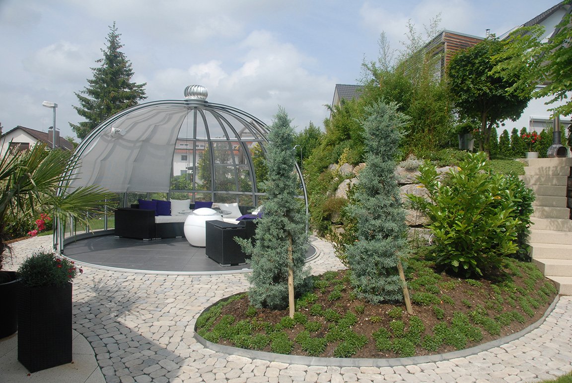 Rondo revolving glass pavilion with garden furniture
